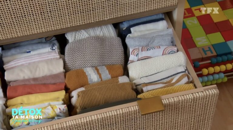 Pliage des vêtements de bébé à la verticale dans ce tiroir en rotin.